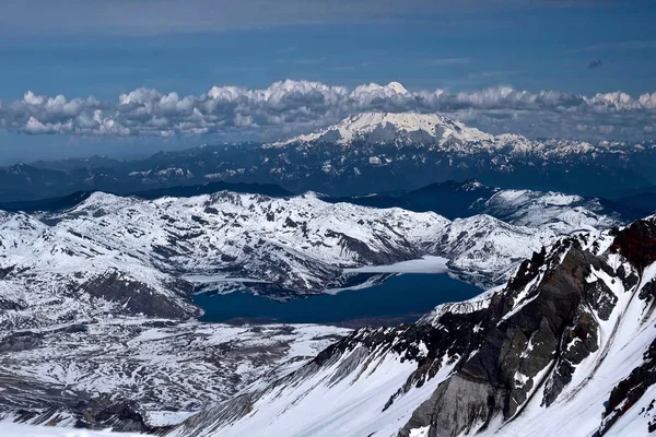 Pacific ring of fire. Spirit Lake and Mount Rainier from Mount Saint Helens summit. View of lake with reflections and  volcano covered with snow.  Mount St Helens National Volcanic Monument. Washington. United States of America