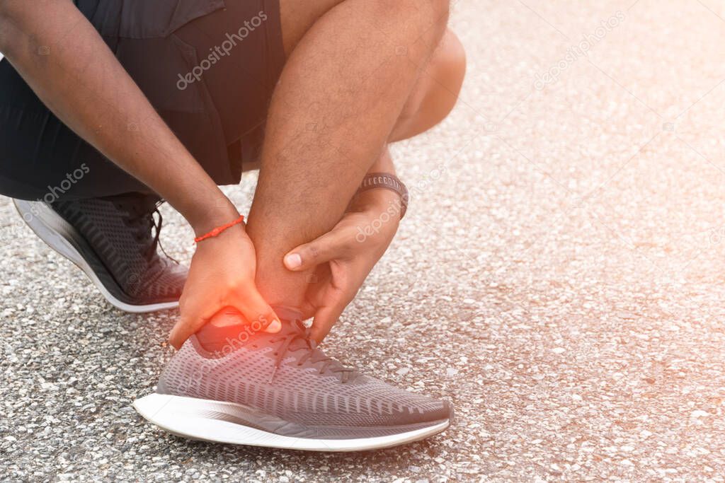 Sore ankle, man injury ankle pain after training running workout, Healthcare Concept