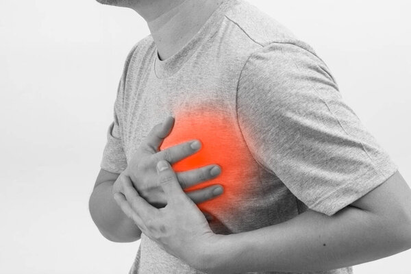 Male with heart attack, heart burn condition or heart pain. Healthcare and Medicine Concept