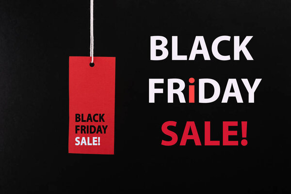 Black Friday sale concept. Red Sale tag color on the black background with Copy space. Black Friday weekend
