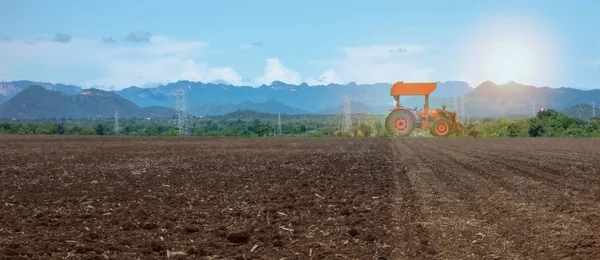 smart farming with agriculture industry 4.0 concept, farmer use tractor in the farm for Plowing, Harrowing, Sowin