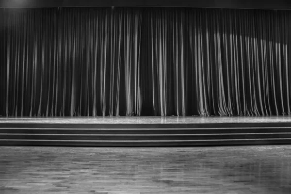 Black and white curtains and wooden stage.