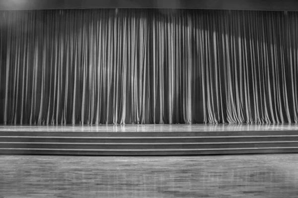 Black and white curtains and wooden stage.