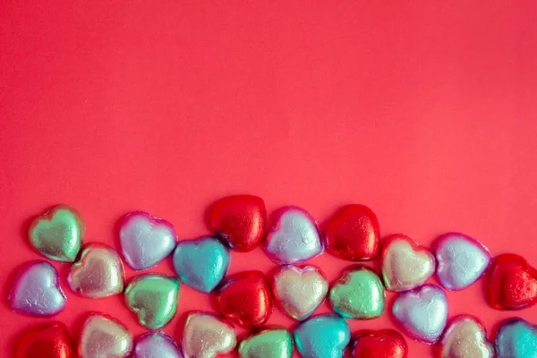 Red background with multicolored heart rests in the concept of V — Stock Photo, Image