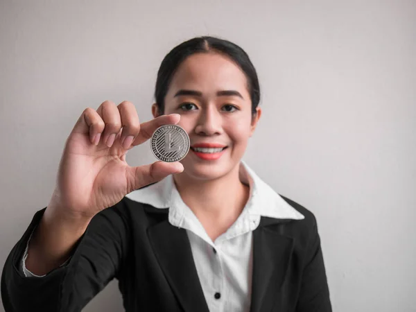 Business woman showing silver litecoin.