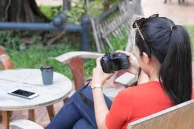 Kadınlar kamera oynuyor ve bir cep telefonu var, bir kahve fincanı i
