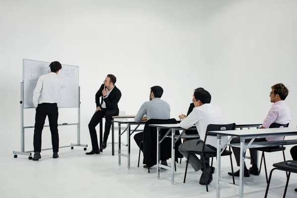 Meeting and planning of working as a team together of Asian people and foreigners at white meeting room. Concept of working together as a team.