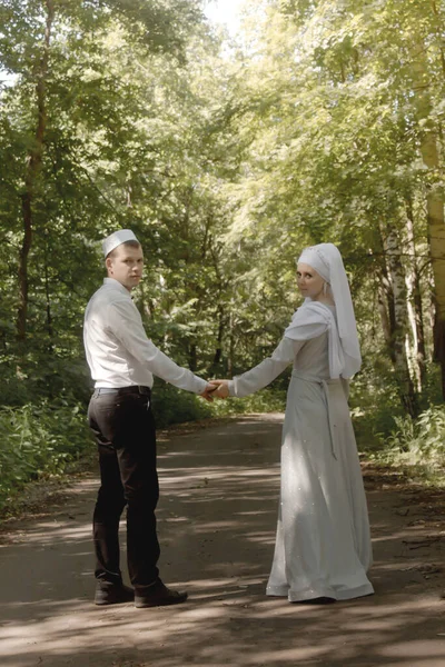 Couple young muslim man and woman on the summer field look to each other. Muslim tatar wedding. Selective focus