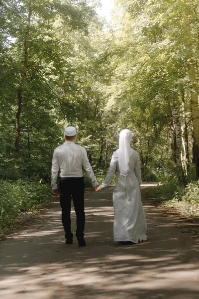 Couple young muslim man and woman on the summer field look to each other. Muslim tatar wedding. Selective focus