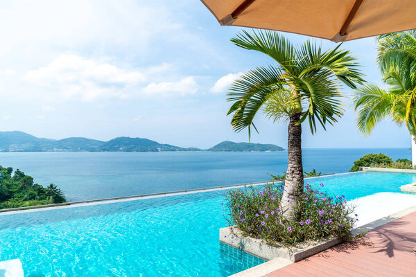 swimming pool in hotel and resort with sky and sea background