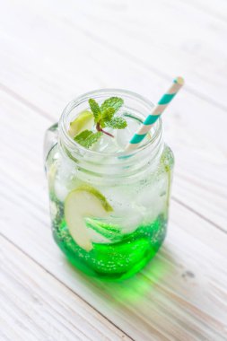 Yeşil elma soda ahşap masa üzerinde