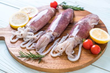 taze ahtapot veya mürekkep malzemelerle ahşap tahta üzerinde ham