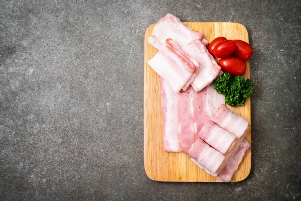 Ahşap tahta üzerinde çiğ domuz pastırma dilimlenmiş