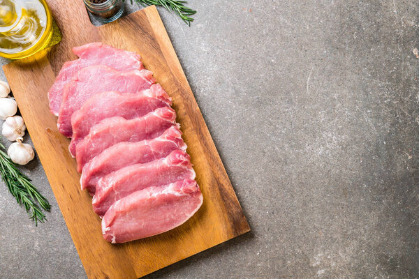 fresh pork raw fillet on wooden board