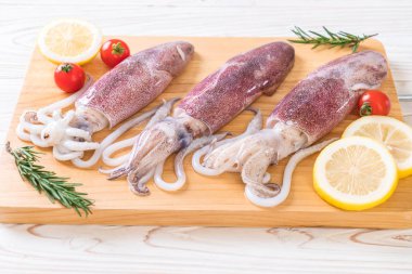 taze ahtapot veya mürekkep malzemelerle ahşap tahta üzerinde ham