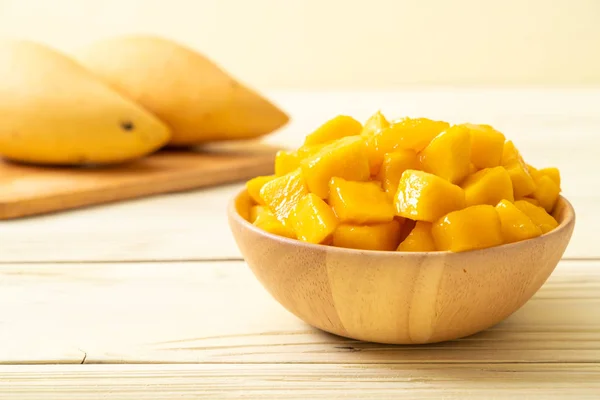 fresh and golden mangoes in bowl