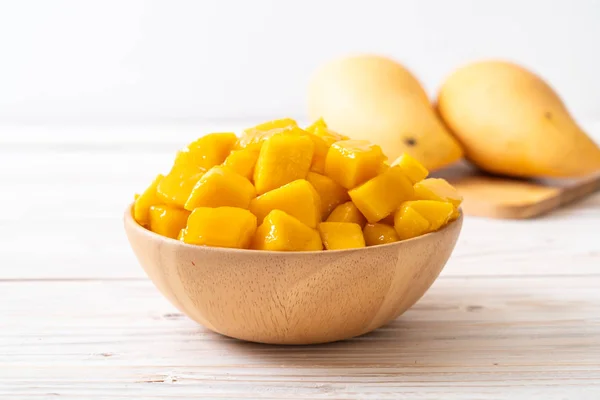 fresh and golden mangoes in bowl