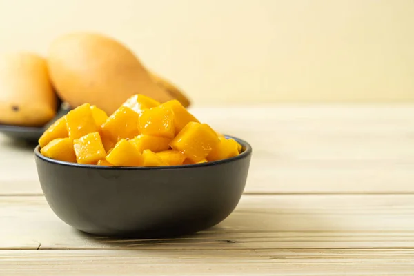fresh and golden mangoes in bowl