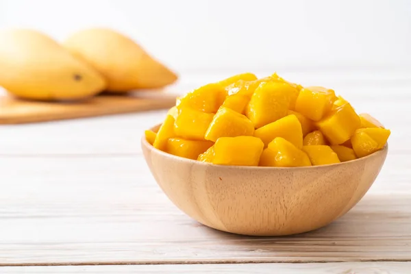 fresh and golden mangoes in bowl