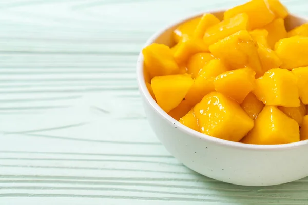 fresh and golden mangoes in bowl