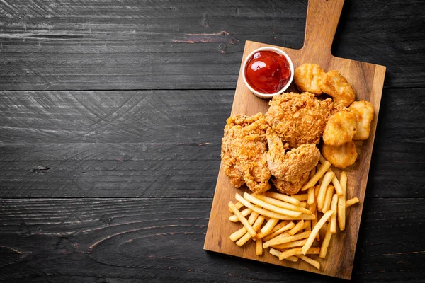 Kızarmış tavuk, patates kızartması ve nugget yemeği. Abur cubur ve sağlıksız yemek.
