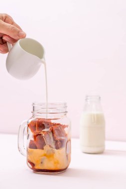 Tay çay buz küpü ile ahşap arka plan üzerinde süt