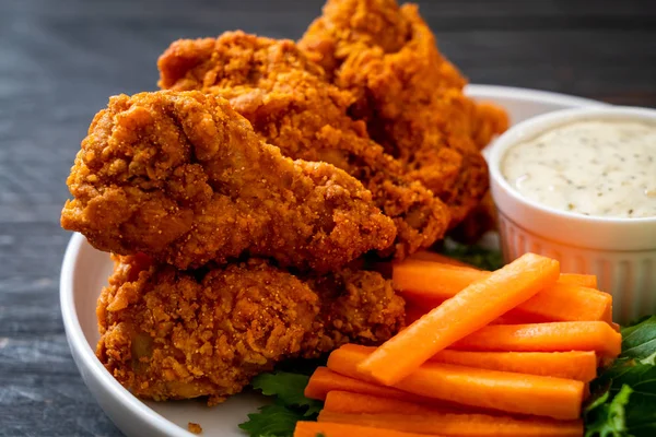 fried spicy chicken wings with vegetable