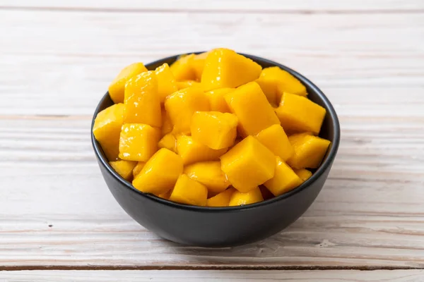 fresh and golden mangoes in bowl