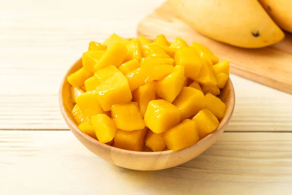 fresh and golden mangoes in bowl