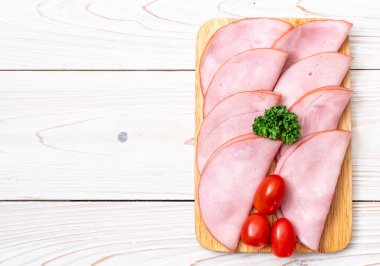 Ahşap tahta üzerinde dilimlenmiş jambon füme