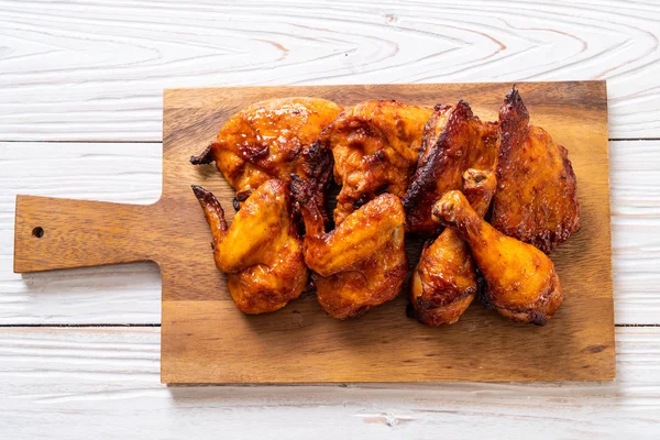 grilled and barbecue chicken on table