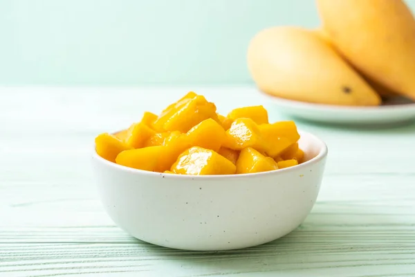 fresh and golden mangoes in bowl