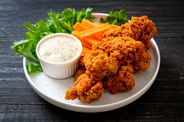 fried spicy chicken wings with vegetable