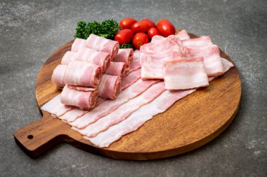 Ahşap tahta üzerinde çiğ domuz pastırma dilimlenmiş