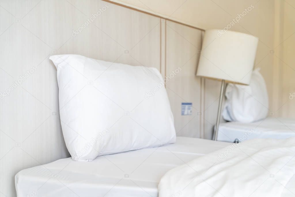Comfortable pillow on bed decoration in hotel bedroom interior