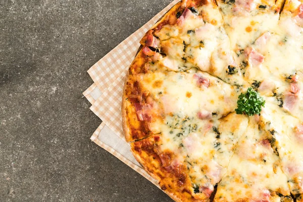 spinach and bacon pizza on table