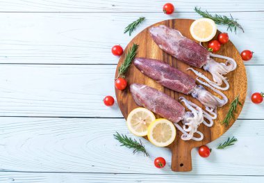 taze ahtapot veya mürekkep malzemelerle ahşap tahta üzerinde ham