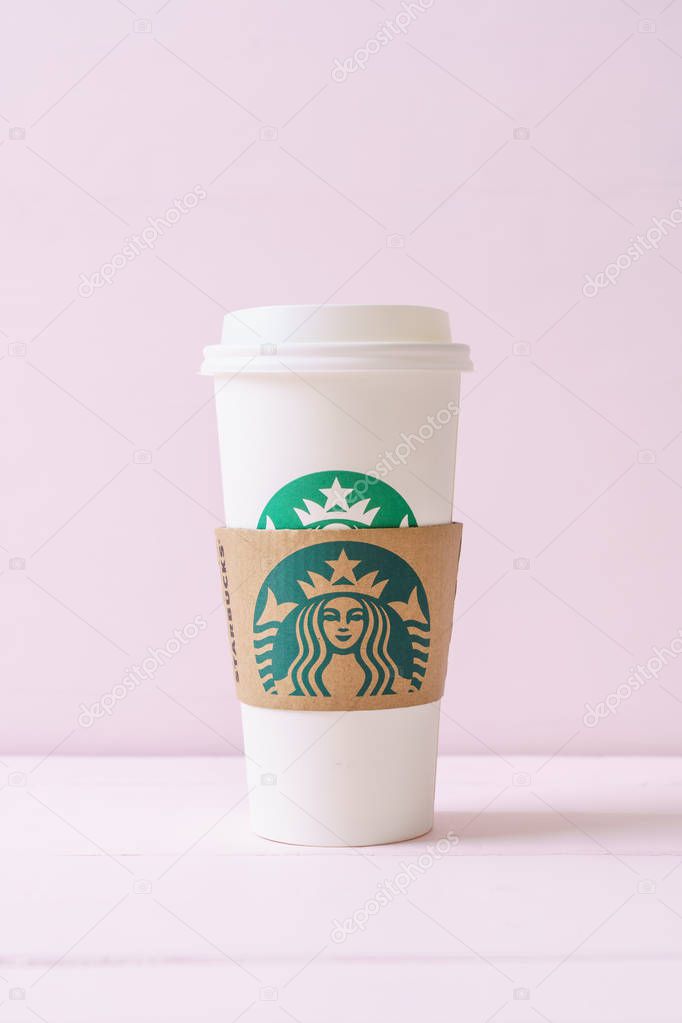 BANGKOK, THAILAND - JUN 5, 2018: White coffee cup with Starbucks logo on wood background. Starbucks is the world's largest coffee house with over 20,000 stores in 61 countries.