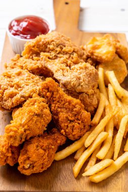 Kızarmış tavuk, patates kızartması ve nugget yemeği. Abur cubur ve sağlıksız yemek.