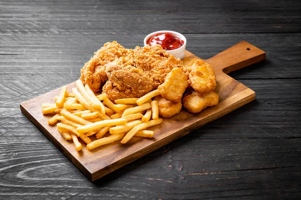 fried chicken with french fries and nuggets meal - junk food and unhealthy food