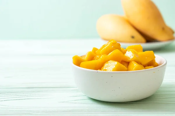 fresh and golden mangoes in bowl