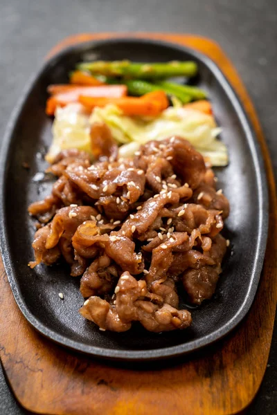 Sliced pork steak on hot plate — Stock Photo, Image