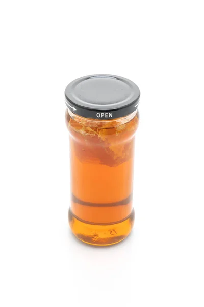 Honigglas auf weißem Hintergrund — Stockfoto