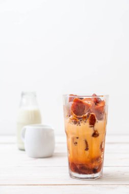 Tay çay buz küpü ile ahşap arka plan üzerinde süt