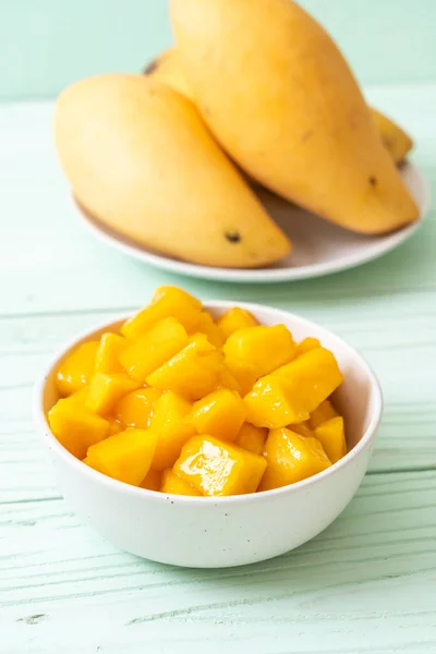 fresh and golden mangoes in bowl