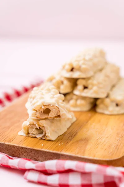 white chocolate with caramel and cereal crispy bar on wood