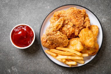 Kızarmış tavuk, patates kızartması ve nugget yemeği. Abur cubur ve sağlıksız yemek.
