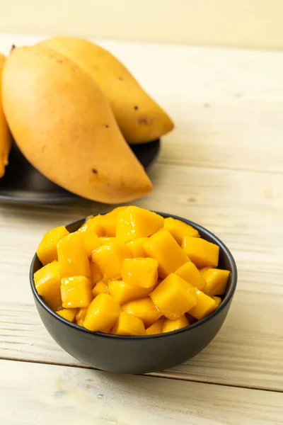 fresh and golden mangoes in bowl