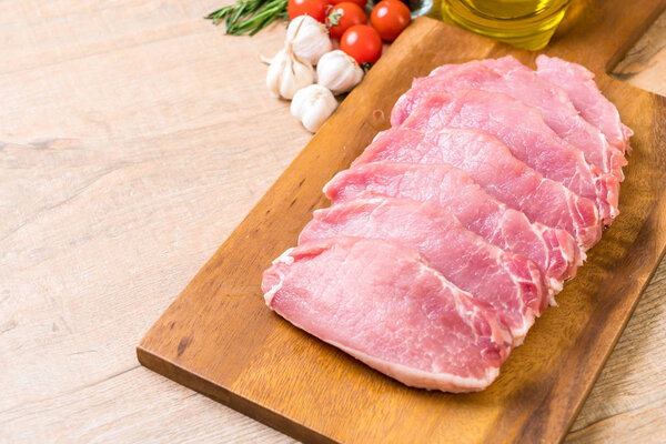 fresh pork raw fillet on wooden board