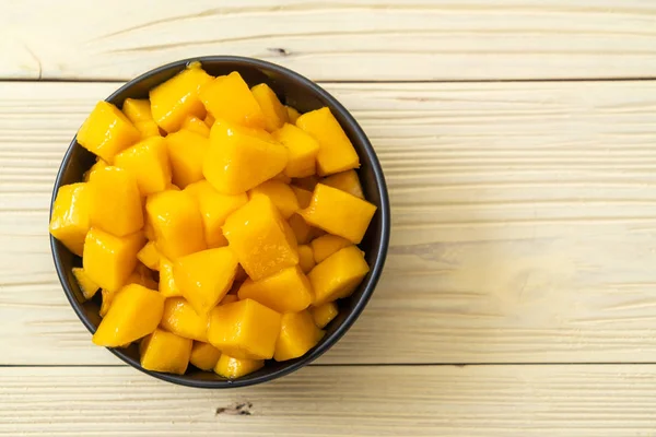 fresh and golden mangoes in bowl